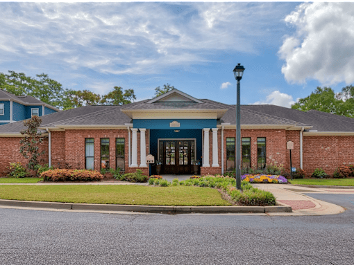 A building with a blue front door and a black lamp post.