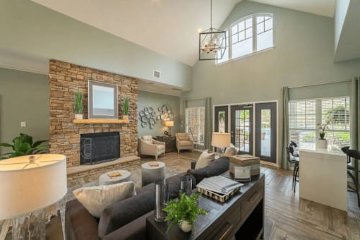 a living room with a stone fireplace and a couch