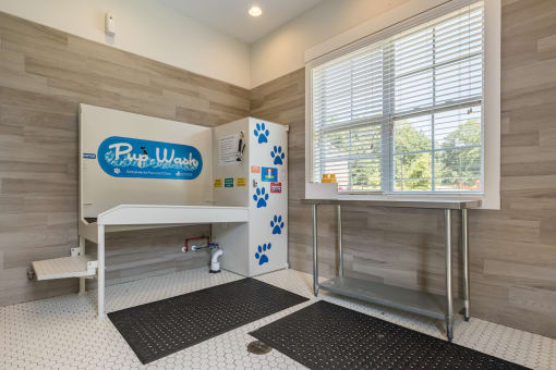 a bathroom with a shower and a sink and a window