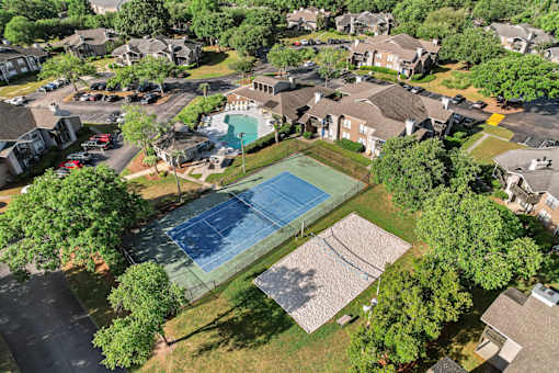 ariel photo of tennis courts and sparkling swimming pool