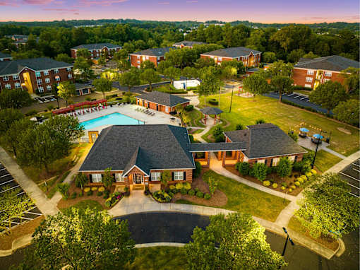 A large building with a pool in front of it.