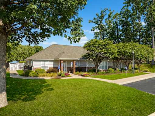 a home in a neighborhood with trees and a sidewalk