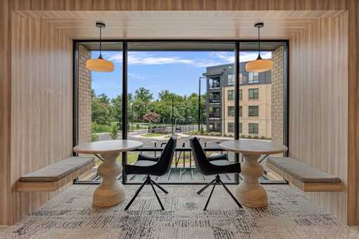 A modern dining area with a view of a cityscape through large windows.