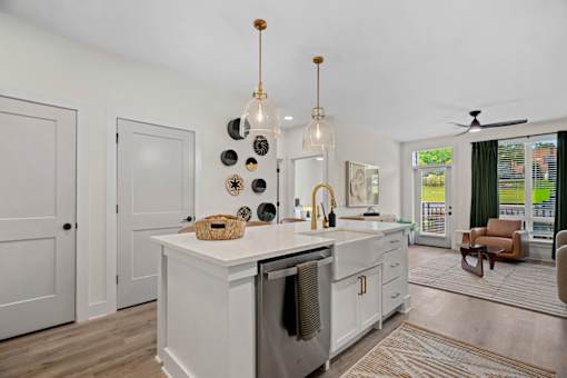 A modern kitchen with a white island and a dishwasher.