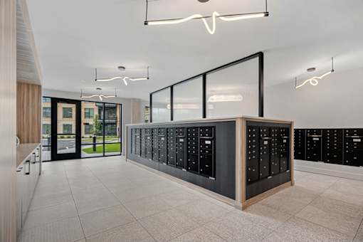 A modern office space with a row of filing cabinets and a glass partition.