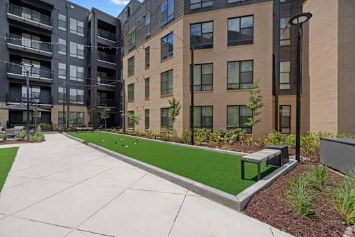 A modern building with a green lawn in front.