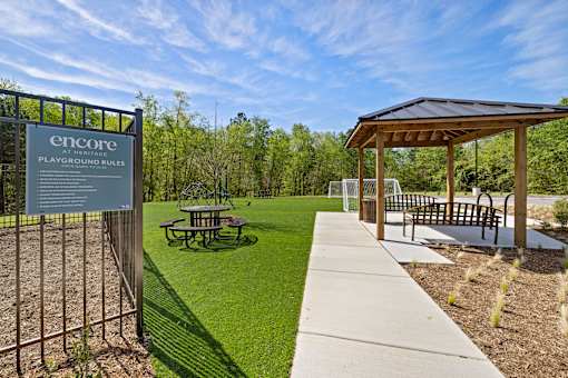 A playground with a sign that reads "Encore Playground Rules".