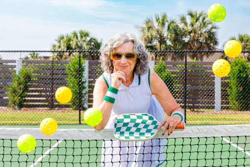A woman is playing tennis and is about to hit the ball.