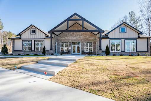 A large house with a grey roof and a white garage door.
