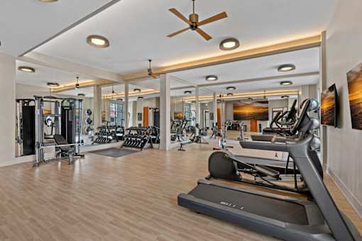 A gym with a variety of exercise equipment