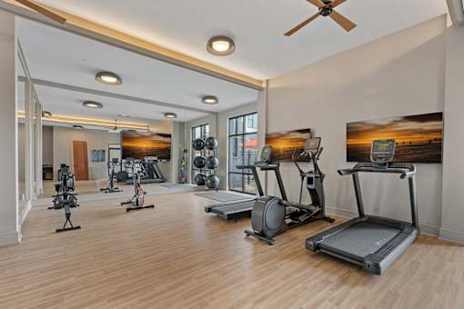 A gym with a variety of exercise equipment