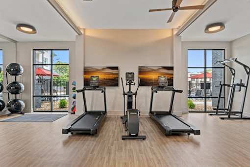 A gym with a variety of exercise equipment