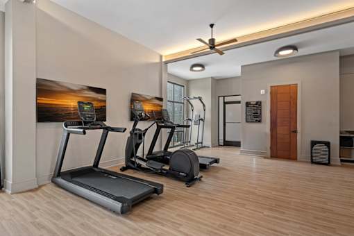 A gym with a variety of exercise equipment
