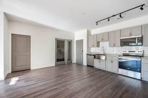 A kitchen with a stove top oven and a refrigerator.