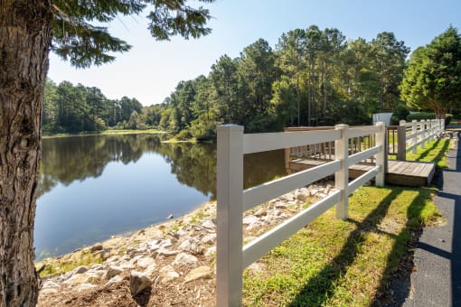 a view of a lake with a white fence