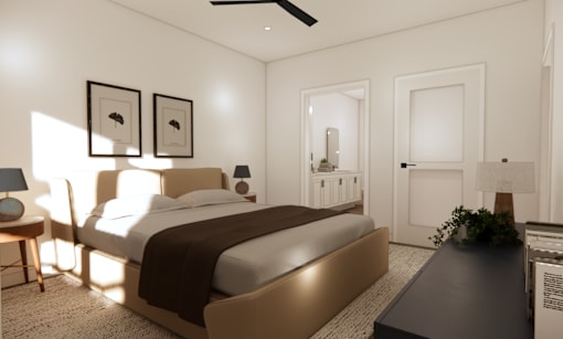 A bedroom with a large bed and a ceiling fan.