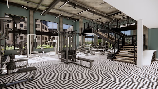 A gym with a striped carpet and various exercise equipment.