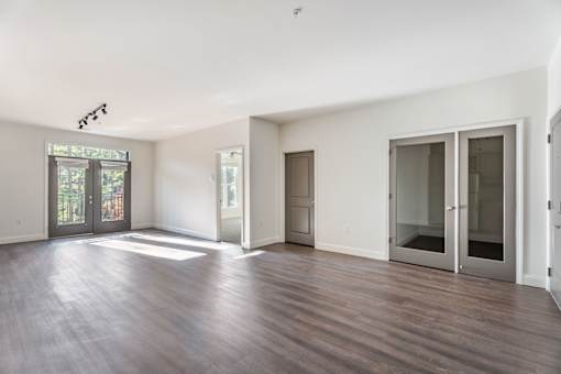 A room with wooden floors and white walls.