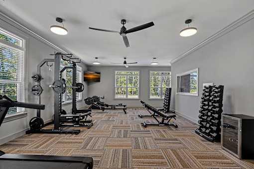 A spacious home gym with a variety of exercise equipment.