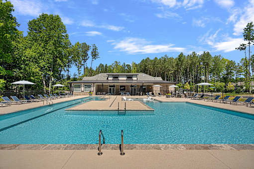 A large swimming pool with a building in the background.