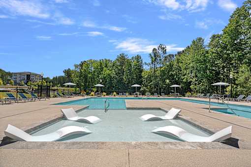 A swimming pool with a person diving into the water.