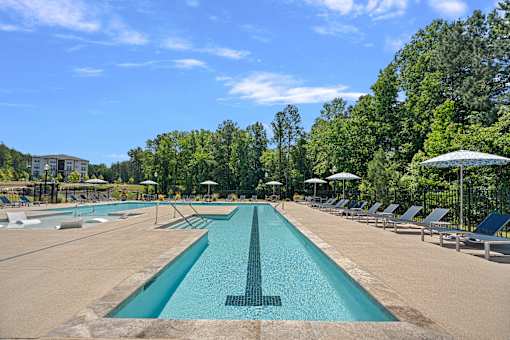 A large swimming pool with a diving board in the middle.