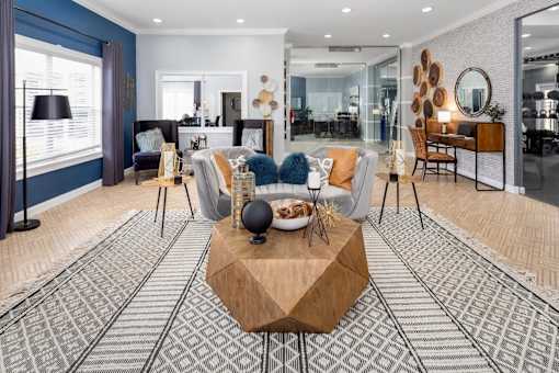 A modern living room with a wooden coffee table in the center.
