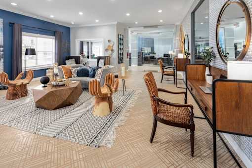 Clubhouse interior with seating and a desk with a chair against the wall.