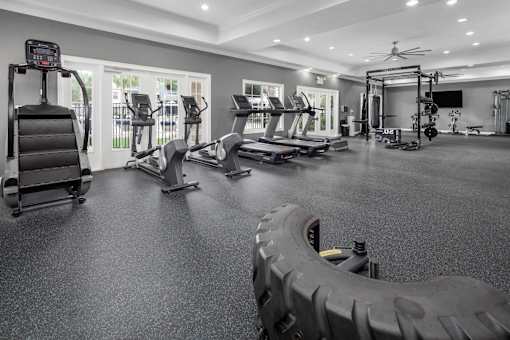 Fitness Center with a tire in the foreground and fitness equipment in the background.