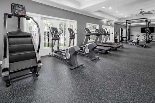 A spacious fitness center with treadmills, elliptical machines, and other exercise equipment.