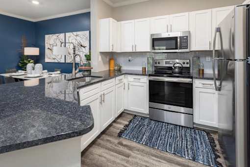 Interior kitchen view of stainless steel appliances.