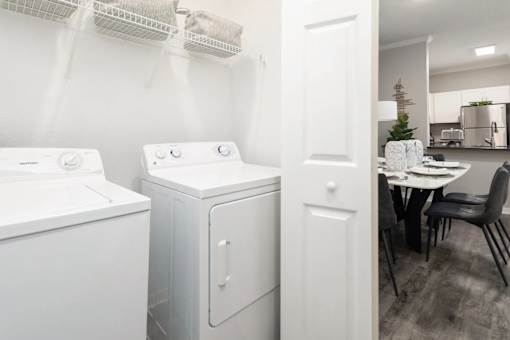 A white washing machine and dryer side by side in a laundry room.
