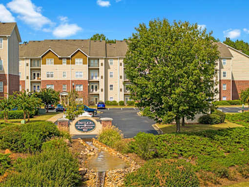 A Davion Plantation residential complex with a small stream running through the front.