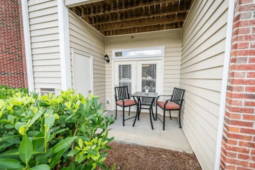 A small patio with a table and chairs.