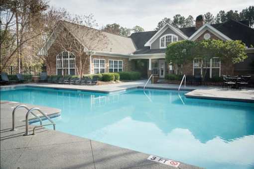 a large swimming pool in front of a house