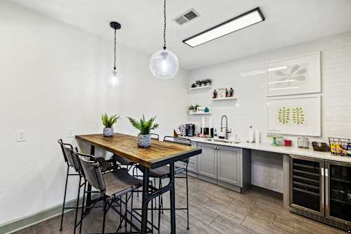 A kitchen with a table and chairs at Evergreen at the Bluffs apartments in Knoxville, TN.