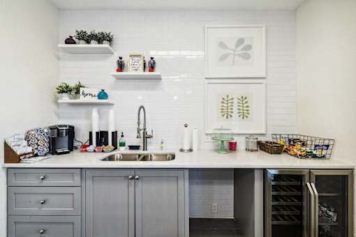 A kitchen with a sink and a refrigerator at Evergreen at the Bluffs apartments in Knoxville, TN..