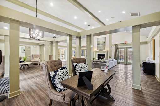 A large, well-lit room with a wooden table and chairs at Evergreen at the Bluffs apartments in Knoxville, TN..