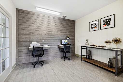 A room with two chairs and a desk with a computer on it at Evergreen at the Bluffs apartments in Knoxville, TN..