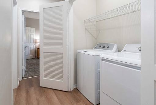 A white laundry room with a washer and dryer.