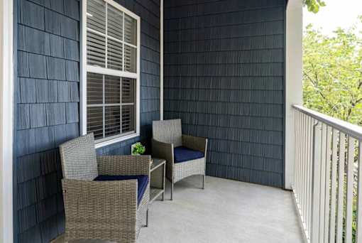 A patio with a table and chairs.