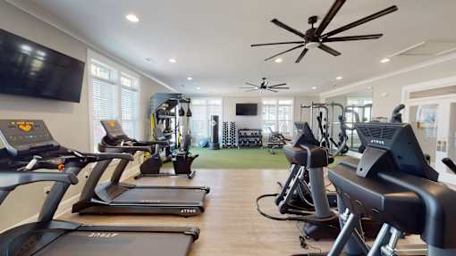 A gym with treadmills and exercise equipment.