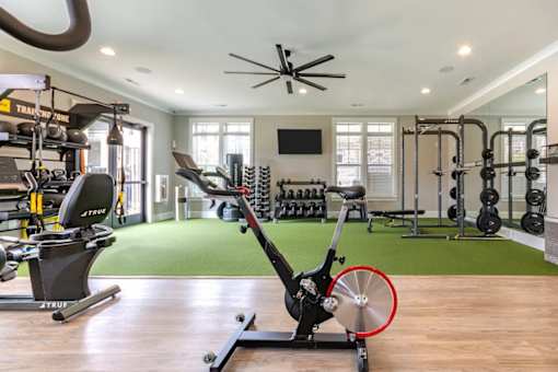 A gym with a TRUFIT rowing machine in the foreground.