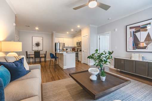 A living room with a couch, chairs, and a coffee table.