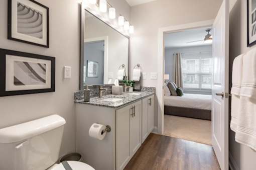 A bathroom with a white toilet and a white sink.