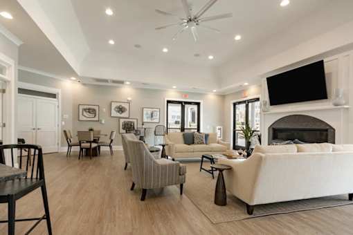 A living room with a fireplace and a television on the wall.