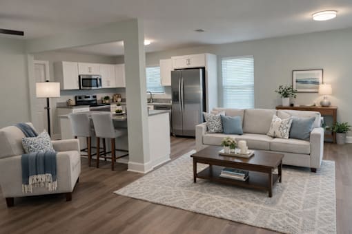 A modern kitchen with a dining area and a living room.