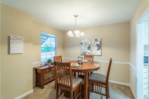 a dining room with a table and chairs