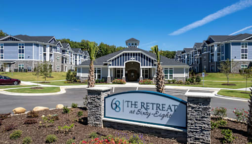 The Retreat at Sixty Eight is a large, modern building surrounded by well-maintained landscaping.