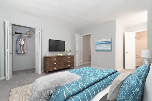 A bedroom with a bed, dresser, and a painting on the wall.